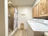 Lower level bathroom with shower, toilet, and sink vanity. Also includes full size washer and dryer for your use, laundry soap is provided.