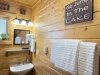 The second bathroom is equipped with a standing shower, sink, and a toilet.