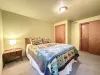 This bedroom is complete with a lamp, bedside table, and a closet to store your belongings.