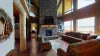 Living room is equipped with a beautiful fireplace, tv for entertainment, and plenty of seating for everyone.