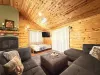 Living room couch and futon bed with a smart tv.