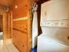 Mud room area on the main level with stacked washer and dryer. Laundry soap is provided.