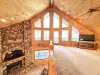 Upstairs loft with tv and seating. Large windows to enjoy the beautiful scenery.