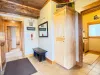 A functional main-floor mudroom at the entrance, offering a bench and storage wardrobe to neatly tuck away shoes and coats.