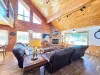 Large open living room with seating, television, and fireplace.