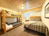 Bedroom #4 located downstairs with Queen and bunk bed.