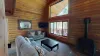 Main level living area with seating, TV, and fireplace.