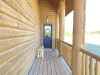 The porch wraps around the whole cabin.
