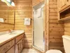 Ensuite bathroom with steam shower, sink, toilet, and storage.