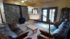 Downstairs living area with fireplace and seating.