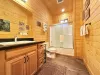 Private bathroom with shower tub combo, toilet, and sink vanity.