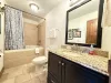 Bathroom #1 on the main level with large tub/shower, toilet, and sink.