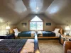 Tucked perfectly under the geometric window are two additional twin beds, allowing this huge loft to comfortably sleep 4 to 6 guests.