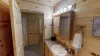 Downstairs shared bathroom with standing shower, toilet, and sink vanity.