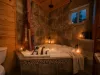 Indulge in a luxurious, candlelit bubble bath in the deep soaking tub, surrounded by beautiful custom tile work and warm natural wood walls.