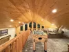 Open to the floor below, the loft overlooks the main living area, with a wooden banister railing made of log posts