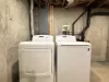 Washer and dryer located downstairs, laundry soap is provided.