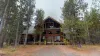 Nestled in the trees is this beautiful handcrafted log cabin.