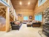 The open kitchen blends seamlessly into the cabin's cozy living area, creating a welcoming space perfect for gathering and unwinding.