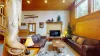 The living room is equipped with seating on the couches and a smart televisions for entertainment.