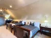 The main sleeping area features two sturdy double beds styled with rustic pine-tree quilts, ideal for a deeply restful night's sleep.