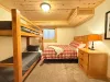 Bedroom #5 located downstairs with Queen bed and bunk bed,