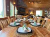 The dining room has a large table with seating and additional seating at the bar of the Island in the kitchen.