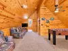 Loft seating area with TV with dvd's for the kids along with a foosball table.