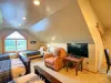 Relax in the cozy leather armchair and catch up on your favorite shows, positioned right alongside the room's comfortable sleeping layout.