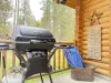 A propane grill on the front porch.