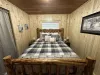 Queen bedroom with flat screen smart tv and closet