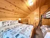 Ideal for guests with little ones, this warm upstairs room includes a comfortable Queen bed, a twin bunk bed, and a wooden baby crib.