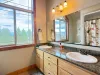 The spacious upstairs bathroom boasts a double sink vanity with granite countertops, offering plenty of space for everyone to get ready.
