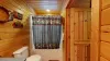 Upstairs bathroom with shower/tub, toilet, and sink.