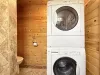Stackable washer and dryer in the bathroom, laundry soap is provided.