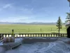 Hot tub with panoramic meadow views.