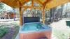 A hot tub is located outside with hot tub towels provided.