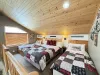 Upstairs loft with a double bed and two twin beds.