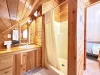 Bathroom with shower, sink vanity, and toilet.