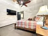 Queen bedroom with flat screen tv and walk in closet.