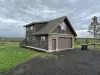 This cabin offers a garage apartment with a sleeping area and bathroom upstairs.