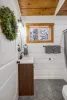 Full size bathroom with hot water on demand and a deep bathtub for soaking.