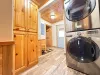 Stacked washer and dryer with laundry soap provided.