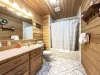 Full size bathroom with a tub shower combo, toilet, and sink.