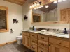 Shared bathroom upstairs with a shower tub combo, toilet, and sink vanity.