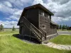 This cabin offers a garage apartment with a sleeping area and bathroom upstairs.