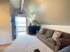 Unwind on the plush brown sofa directly beside the private entrance door, opening up to clean mountain air and stunning outdoor views.