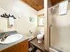 Bathroom #2 on the main level with standing shower, toilet, and sink vanity.