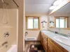 Bathroom #3 located upstairs with shower/tub, toilet, and double sinks.