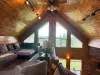 Enjoy the ultimate cabin vibe in this cozy upper loft, nestled under dramatic sloped wood ceilings with track lighting and endless charm.